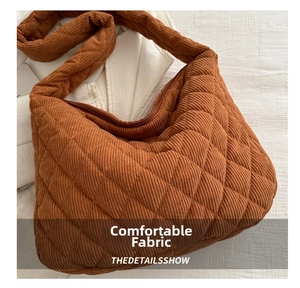 Detailed close-up of dark brown corduroy quilted tote bag with diamond stitching pattern