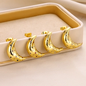 Detailed view of four crescent moon earrings with colorful zircon stones on gold plating