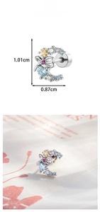 Detail of C-shaped earring with colorful heart zircon stones and bowknot element