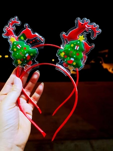 Cute Christmas headband with PVC glitter deer and tree charms against night lights