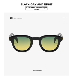 Close-up of black frame sunglasses with yellow-green gradient lenses and gold metal trim