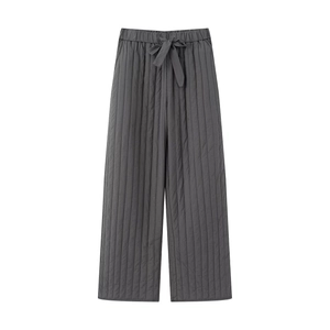 Detail of dark grey quilted wide-leg trousers with elastic waistband and drawstring cord