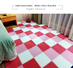 Detail of interlocking plush puzzle mat in white, pink and rose red checkerboard pattern
