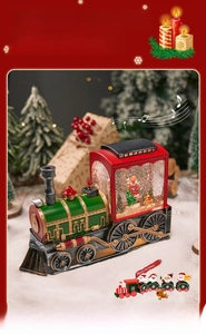 Macro detail of Christmas steam train music box with glowing snow globe and Santa Claus