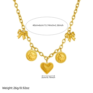 Gold plated stainless steel O-chain necklace with coin and heart charms on white background