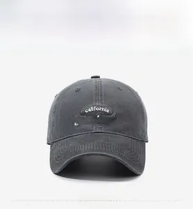 Close-up of white California Standards embroidery on vintage washed grey cotton baseball cap
