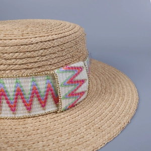 Bohemian raffia flat top straw hat featuring colorful embroidery and bead trim detailing