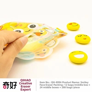 Set of cute yellow emoji erasers in packaging featuring various smiling facial expressions