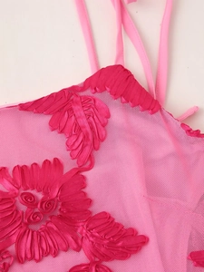 Close-up of pink mesh dress featuring detailed 3D floral embroidery and fine texture