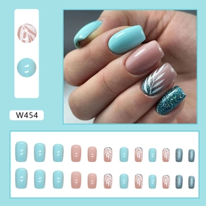 Square fake nails in light blue and pink with leaf patterns and blue glitter finish