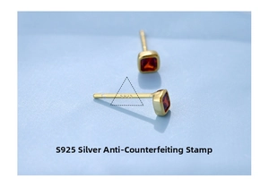 Detail shot of the S925 silver stamp on gold-plated square red zircon stud earrings