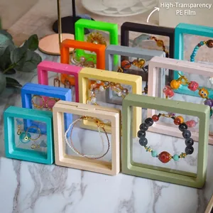 PE film jewelry display boxes in multiple colors showing suspended necklaces and rings