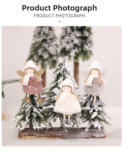 Detailed view of plush Christmas angel ornaments with knit hats and glittery wings