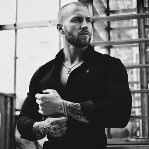 Men's trident pendant necklace in hip-hop style worn with a black slim-fit shirt