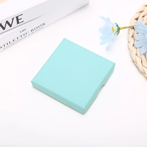 Detailed view of light blue square jewelry box with elegant textured finish
