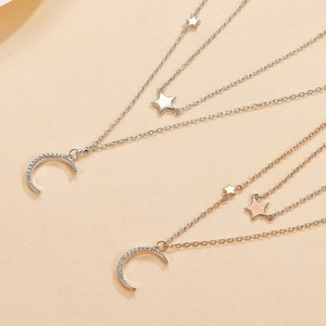 Macro shot of double-layered S925 silver star and moon necklace with cubic zirconia