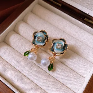 Vintage floral pearl earrings with blue enamel petals and sparkling gold accents