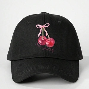 Black cotton baseball cap featuring cherry print, pink bow, and Have a good day text