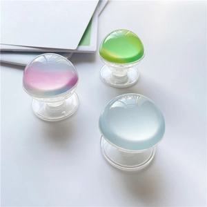 Translucent crystal ball phone socket stands in gradient pink, yellow, and blue colors