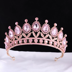 Detail of pink crystal bridal tiara with pear-shaped rhinestones on white silk fabric