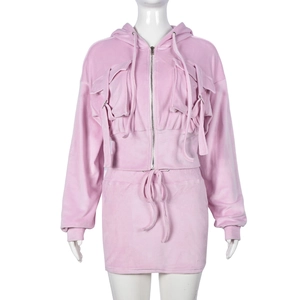 Pink velvet tracksuit detail with cropped zip-up hoodie and matching mini skirt
