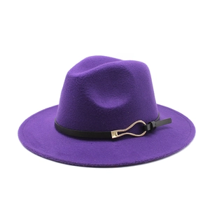 Detailed macro view of deep purple wool fedora with thin black leather strap and gold buckle