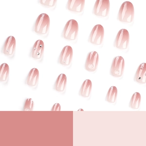 Pink gradient press-on nails with glitter French tips and pearl rhinestone accents