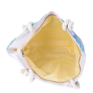 Macro shot of large capacity floral beach bag showing yellow lining and rope handles
