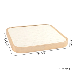 Square jewelry display tray in gold finish with velvet slots for rings and bracelets