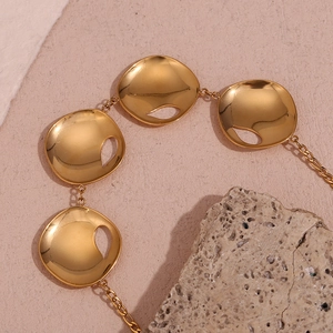 Detail of 18K gold-plated stainless steel necklace with four hollow circular teardrop pendants