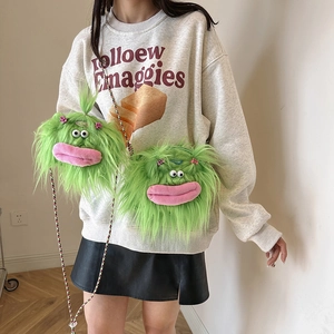 Cute green plush monster crossbody bag with long braided straps and funny big mouth