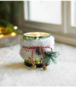 Detailed view of Christmas glass candle holder with green gold finish and fur collar
