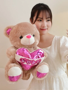Detailed texture of brown teddy bear holding a pink shiny LOVE heart plush toy