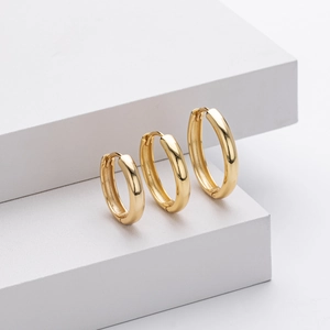 Three pairs of polished gold hollow hoop earrings in small, medium, and large sizes
