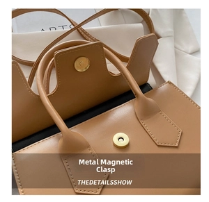 Close-up of high-quality magnetic snap closure on light brown leather handbag