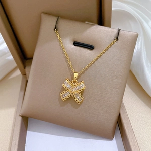 Detail of gold butterfly necklace featuring baguette-cut sparkling zircon crystals