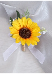 Close-up of sunflower wedding boutonniere with twine handle and white organza bow