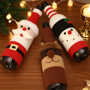 Knitted Christmas wine bottle covers featuring Santa, reindeer, and snowman designs