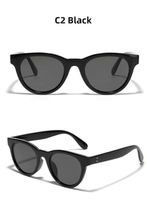 Detail view of round black sunglasses featuring silver double rivet hinge accents
