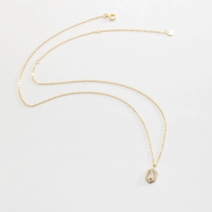 Detail of 925 silver gold-plated necklace showing lobster clasp and zircon pendant