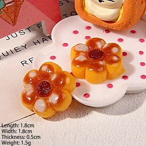 Macro view of flower-shaped resin food charms measuring 1.8x1.8x0.5cm for DIY crafts