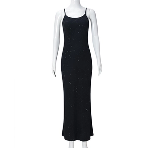Detail of slim straps and shimmering silver sequins on a black bodycon evening dress