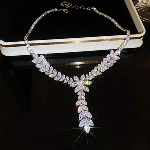 Detailed close-up of a silver wheat tassel necklace with sparkling zircon leaf pendant