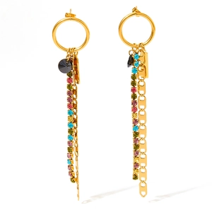 Golden drop earrings with tassel rhinestones and black gem pendant on white background