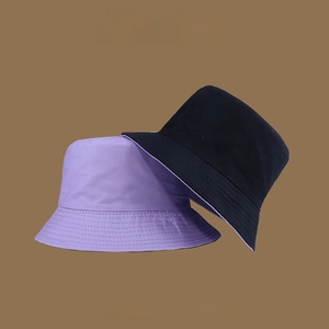 Detail of reversible sun hat showing purple and black cotton fabric texture with wide brim
