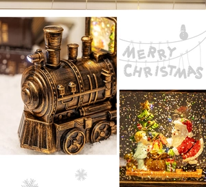 Detail of vintage Christmas train snow globe featuring Santa and a child with warm LED light