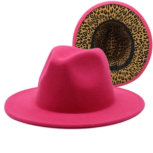 Detail of rose red fedora hat featuring a leopard print lining and wide flat brim