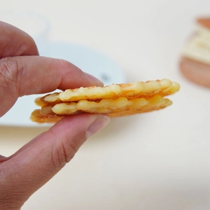 Realistic artificial waffle crisp biscuits with golden grid pattern for shop display