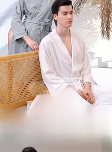 Detailed waffle weave texture on soft absorbent long-sleeved bathrobe with tie waist