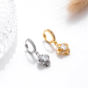 Detail of silver and gold flower drop earrings with sparkling cubic zirconia crystals